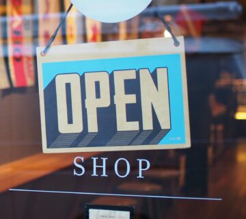 A sign that reads open on a window.