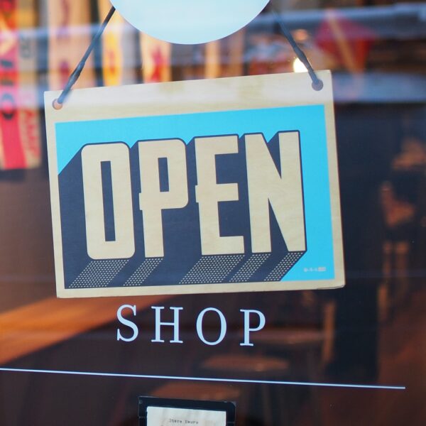 A sign that reads open on a window.