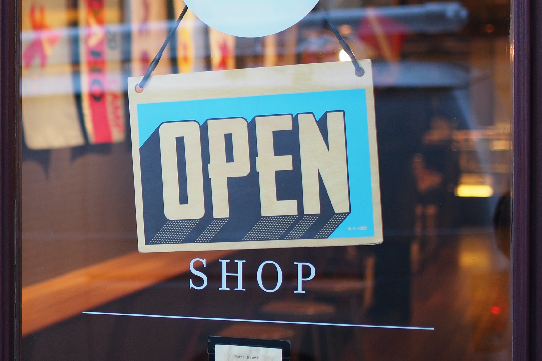 A sign that reads open on a window.